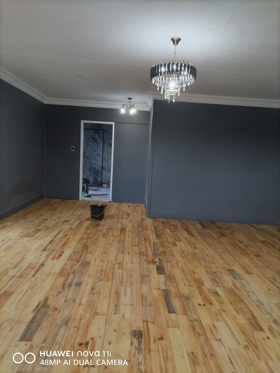 Open lounge with hardwood floor and chandelier