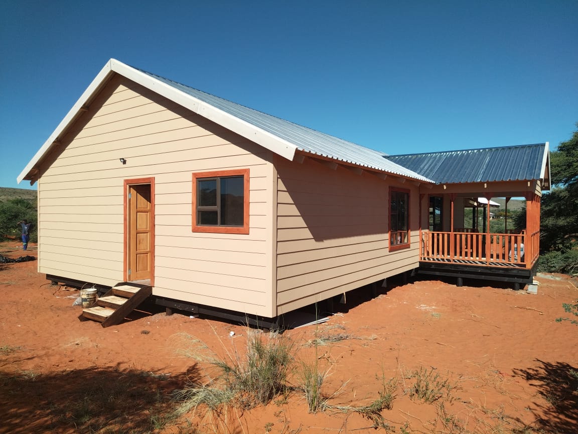 Cream Nutec home with wooden deck