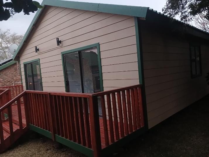 Cream Nutec cabin with green trim